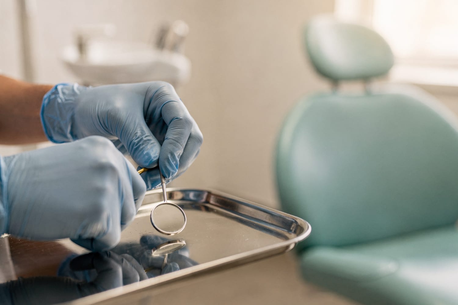 A dentist's gentle, gloved hands preparing to work at an unhurried pace